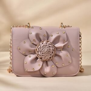 faux leather crossbody bag with a 3D flower design and a golden chain strap.