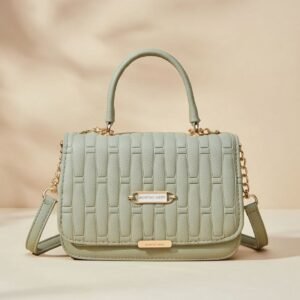 women's quilted top handle crossbody bag in a light green or sage color.