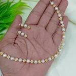 Elegant Floral Stone Studded Pearl Necklace with Matching Earrings.