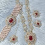 bridal jewelry set featuring a necklace, choker, earrings, and a maang tikka