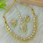 ndian-style antique Kundan jewellery set includes a necklace, earrings, and a maang tikka,