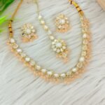 ndian-style antique Kundan jewellery set includes a necklace, earrings, and a maang tikka,