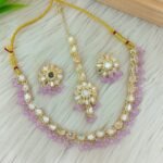 ndian-style antique Kundan jewellery set includes a necklace, earrings, and a maang tikka,