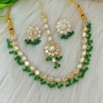 ndian-style antique Kundan jewellery set includes a necklace, earrings, and a maang tikka,