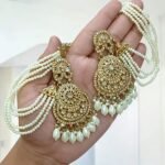 golden tana earrings featuring a multi-layered pearl chain design.