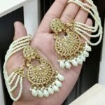 golden tana earrings featuring a multi-layered pearl chain design.