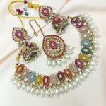 colorful Kundan and pearl choker necklace set with matching earrings and a maang tikka