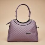 purple quilted synthetic leather satchel handbag with a top handle and shoulder strap.