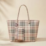 Burberry Medium Reversible Bloomsbury Tote in the classic Nova Check coated canvas with a chain strap.