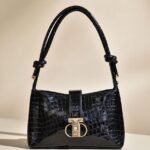 black shoulder bag with a bow detail.