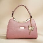 pink PU leather handbag with a butterfly charm.