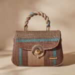 small woven straw top-handle bag with blue and brown stripes, but the specific brand and model are unknown.
