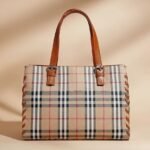 Burberry Check tote bag in a coated cotton blend with leather trim.