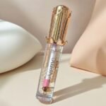 Kiss Beauty Magic Lip Oil, a color-changing lip gloss with a crown-shaped gold cap.
