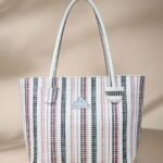 Guess Vikky II 2-in-1 tote bag in a multi-logo pattern and likely made of faux leather. )