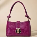 Sandro Janet shoulder bag in a magenta/fuchsia mock-croc leather.