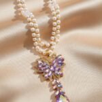 necklace features a trendy double-strand pearl chain
