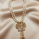 necklace features a trendy double-strand pearl chain