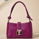 Sandro Janet shoulder bag in a magenta/fuchsia mock-croc leather.