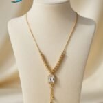 gold-colored pendant necklace